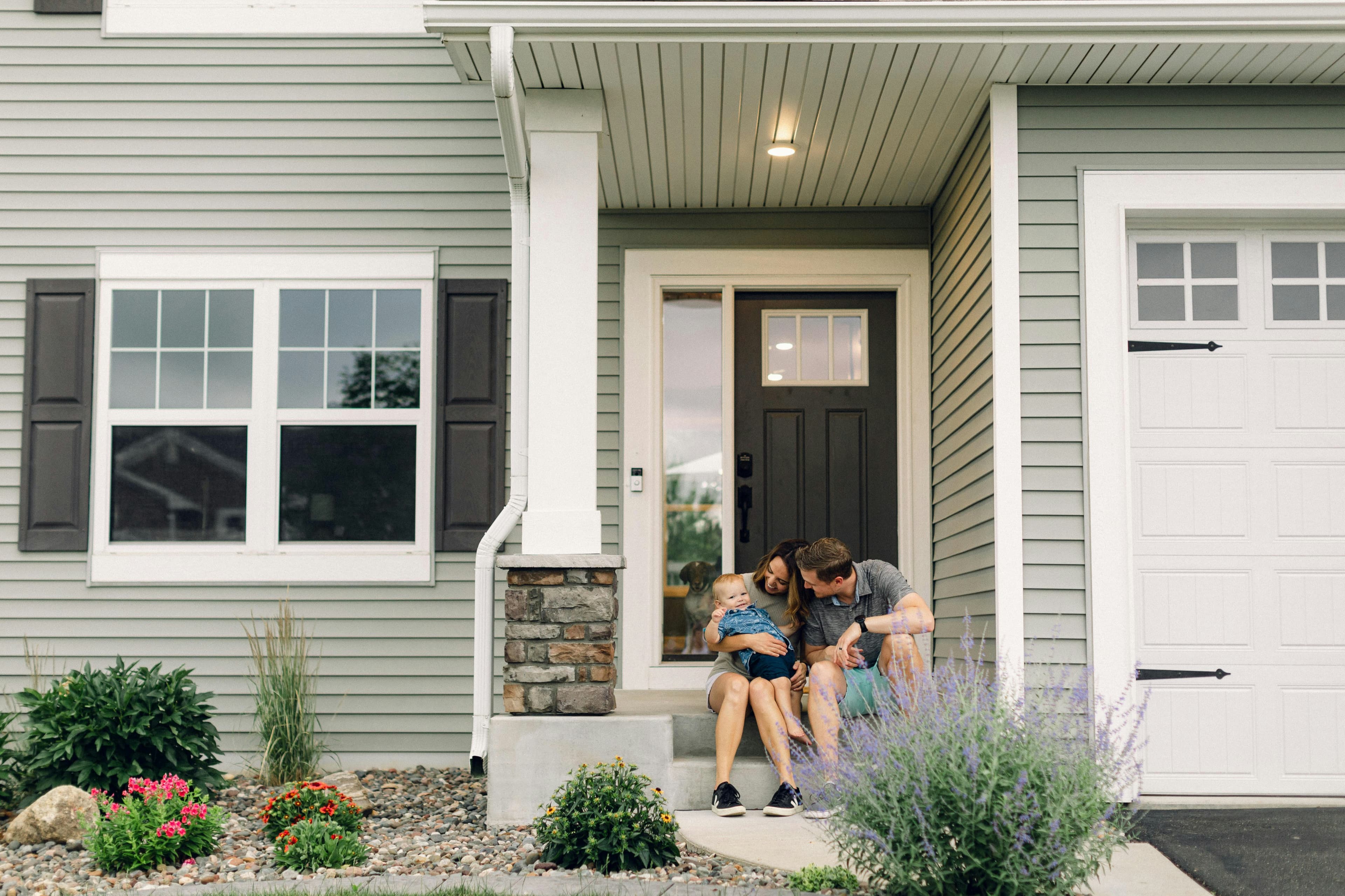 Family in front of their new home